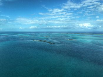 Scenic view of calm sea against cloudy sky