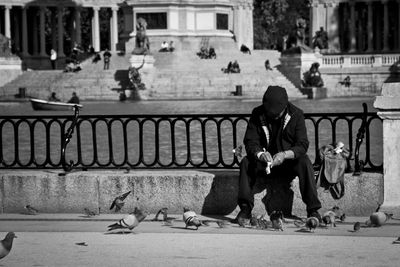 Full length of woman standing by railing