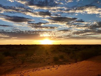 Scenic view of land against sky during sunset
