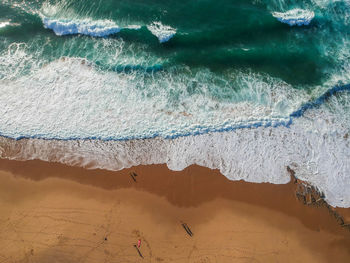 High angle view of surf on beach