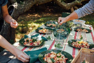 Cropped hand preparing food on table