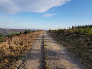 Dirt road along countryside landscape