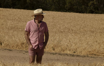 Adult man in hat in wheat field