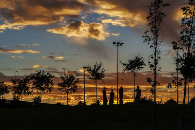 Silhouette palm trees against sky during sunset