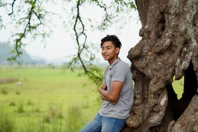 Full length of young man standing on field