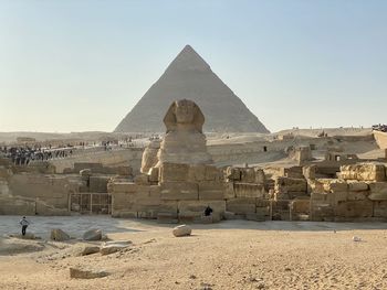 Sphinx and pyramid of khafre against clear sky