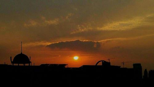 Silhouette of built structure at sunset