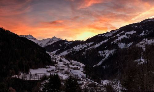 Scenic view of snowcapped mountains against sky during sunset