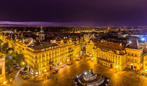 High angle view of city lit up at night