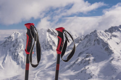 Flag on snowcapped mountains against sky