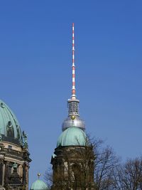 Low angle view of fernsehturm against blue sky