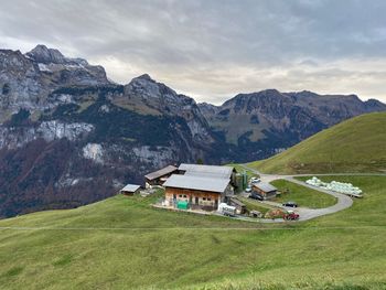 Scenic view of field and houses against sky