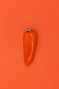 High angle view of orange fruit against red background