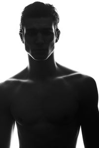 Low angle view of shirtless man against white background