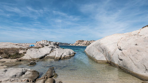 Rock formations in sea against sky