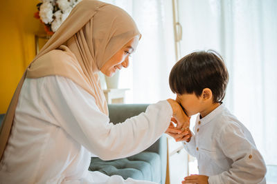 Side view of doctor examining patient at home