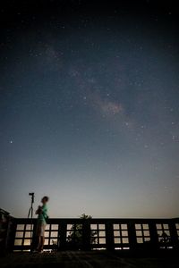 Low angle view of silhouette man standing against sky at night