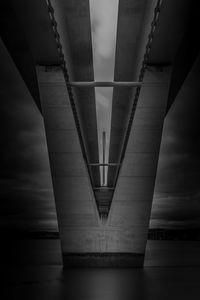 Low angle view of bridge over sea against sky