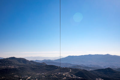 Scenic view of mountains against clear blue sky