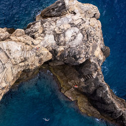 High angle view of rock formations in sea