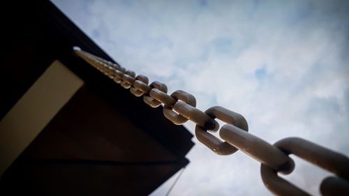 Low angle view of metal against sky