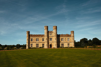 Castle on field against sky