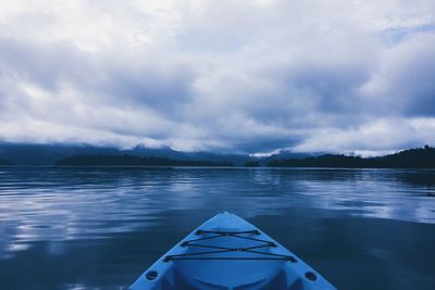 Boat sailing in lake against sky