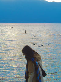 Rear view of woman looking at sea against sky