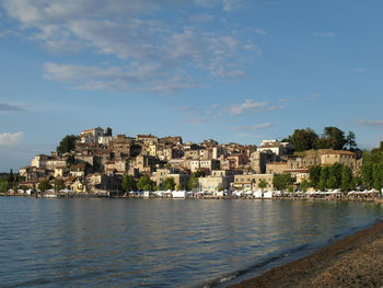 Scenic view of sea by city against sky