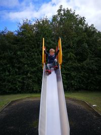 Full length of boy on slide at park