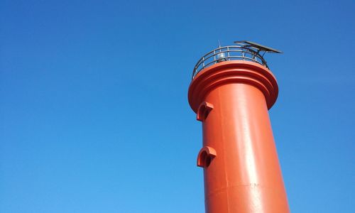 Low angle view of lighthouse against clear blue sky