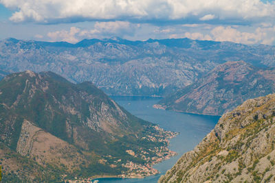 High angle view of lake and mountains against sky