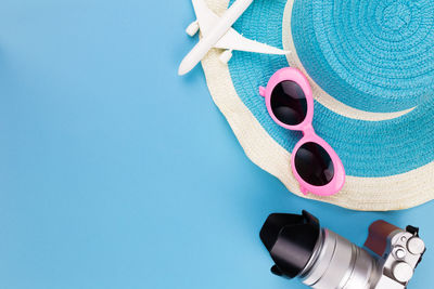 Close-up of sunglasses against blue background