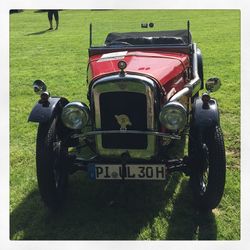 Close-up of vintage car on field