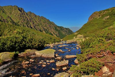 Scenic view of mountains against clear blue sky