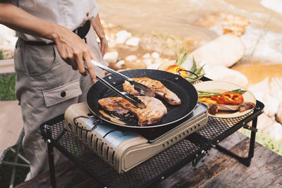 Midsection of man preparing food