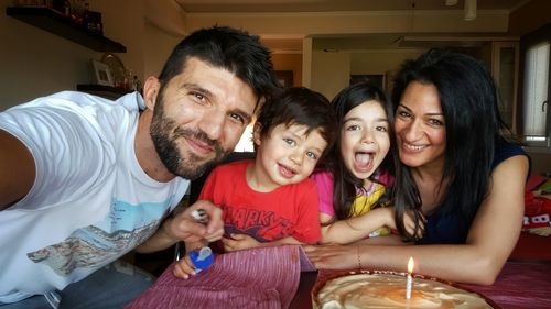 Portrait of cheerful family celebrating birthday at home