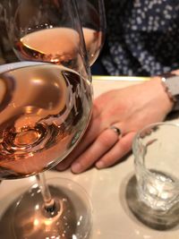 Close-up of hand holding drink served on table