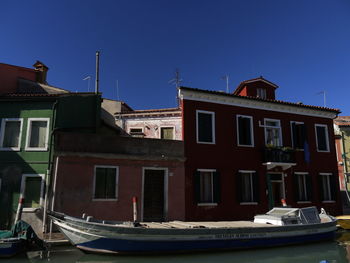 View of residential buildings against blue sky