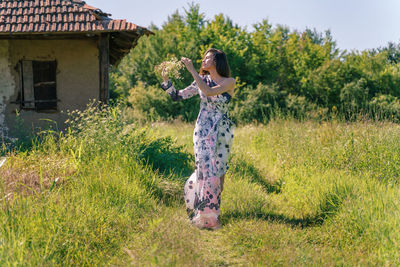 Full length of woman standing on field