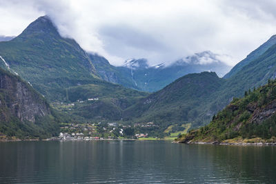 Scenic view of lake and mountains against sky