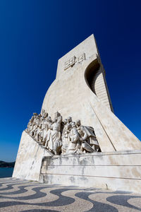 Low angle view of statue against blue sky