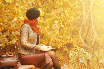 Woman sitting in autumn