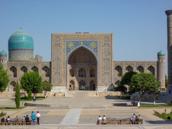 Group of people in temple against clear sky