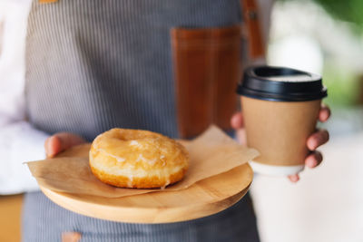 Cropped hand of person holding food