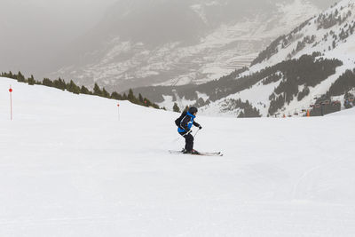 Full length of man skiing on snowcapped mountain