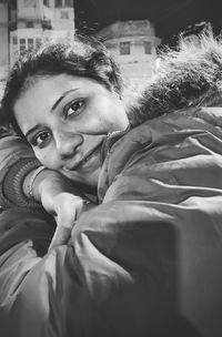 Portrait of smiling girl lying on bed