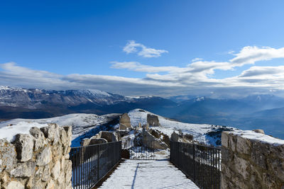 Scenic view of snowcapped mountains against blue sky