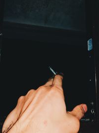 Close-up of hand holding cigarette