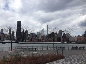 Buildings against cloudy sky